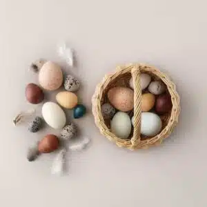 A dozen handmade wooden bird eggs in a basket - Moon Picnic & Erzi