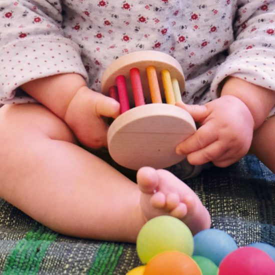 Handmade sustainable wooden baby sensory toy mini Rainbow rolling wheel Grimm's